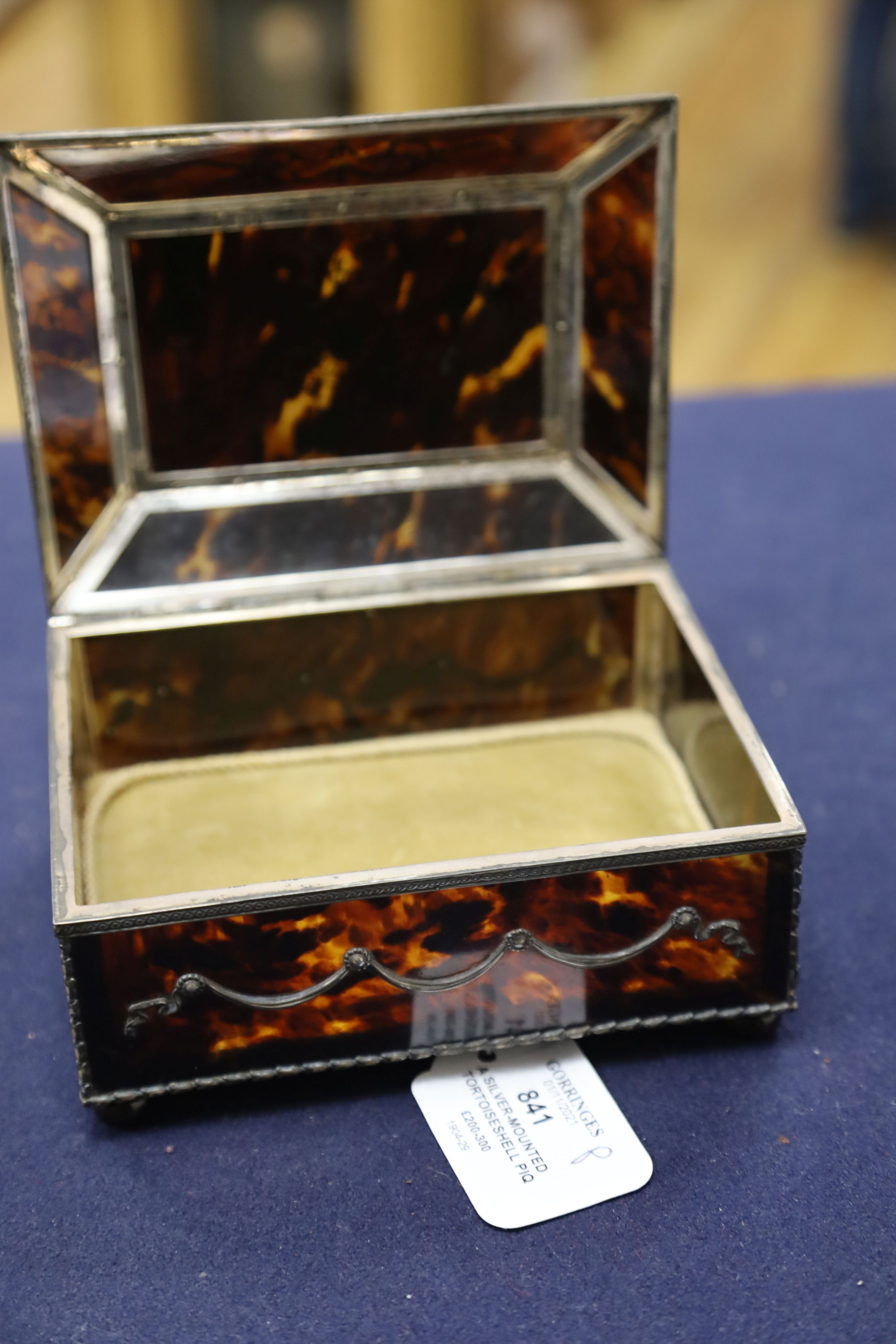 A silver-mounted tortoiseshell pique rectangular trinket box, by William Comyns, raised on four ball feet, London, 1904, width 15cm. 15cm